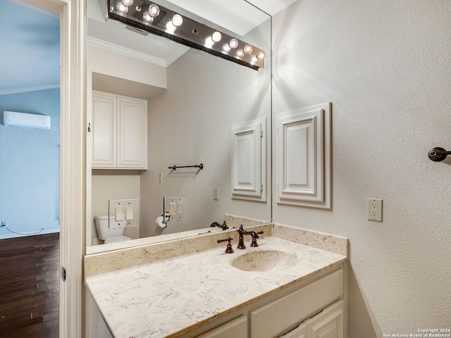 bathroom with wood-type flooring, vanity, toilet, and crown molding