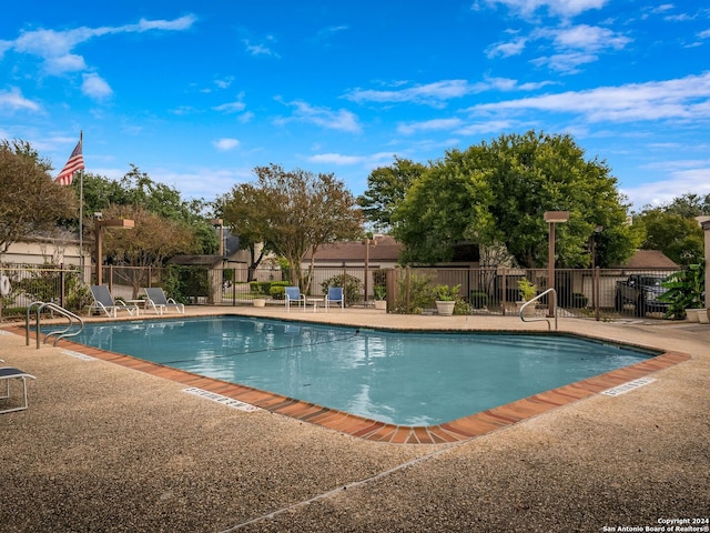 view of swimming pool with a patio area