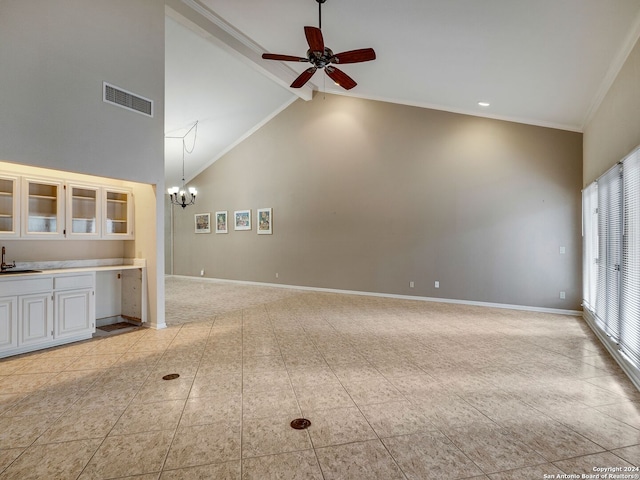 unfurnished living room featuring high vaulted ceiling, ceiling fan with notable chandelier, sink, ornamental molding, and light colored carpet