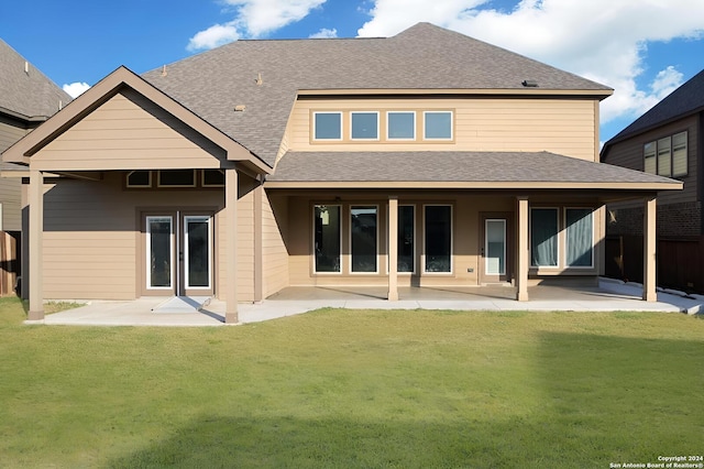 back of property featuring a lawn and a patio