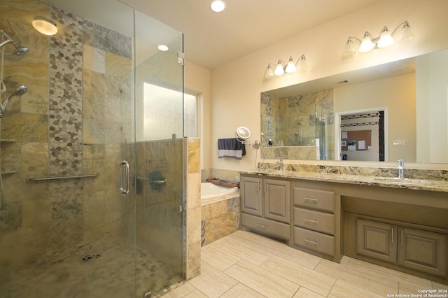 bathroom featuring vanity and shower with separate bathtub