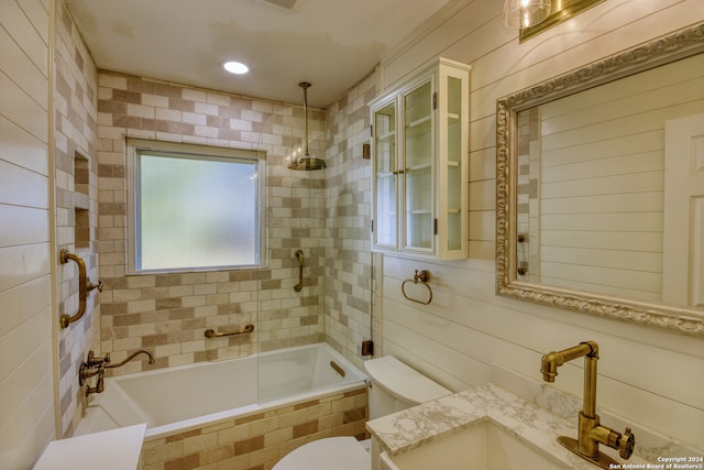 full bathroom featuring vanity, toilet, and tiled shower / bath combo