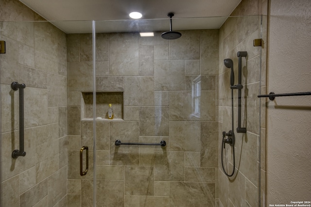 bathroom featuring a shower with shower door