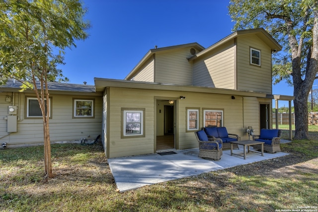 rear view of house with outdoor lounge area and a patio