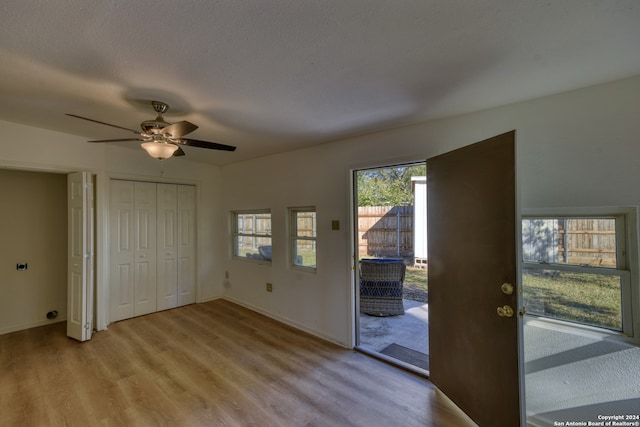 foyer featuring ceiling fan and light hardwood / wood-style flooring