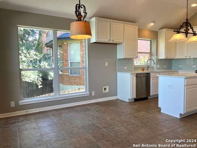 kitchen featuring dishwasher, lofted ceiling, hanging light fixtures, decorative backsplash, and white cabinetry