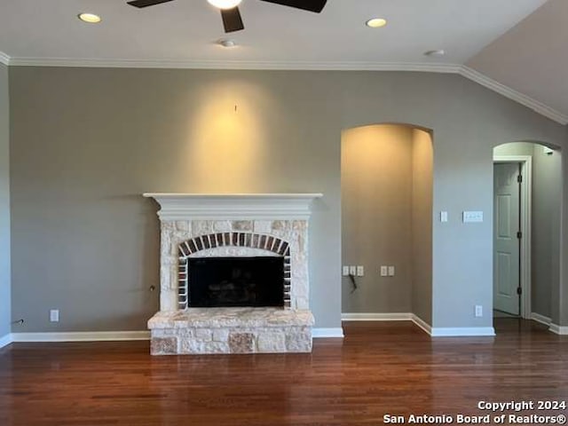 unfurnished living room with a fireplace, ornamental molding, dark wood-type flooring, and vaulted ceiling