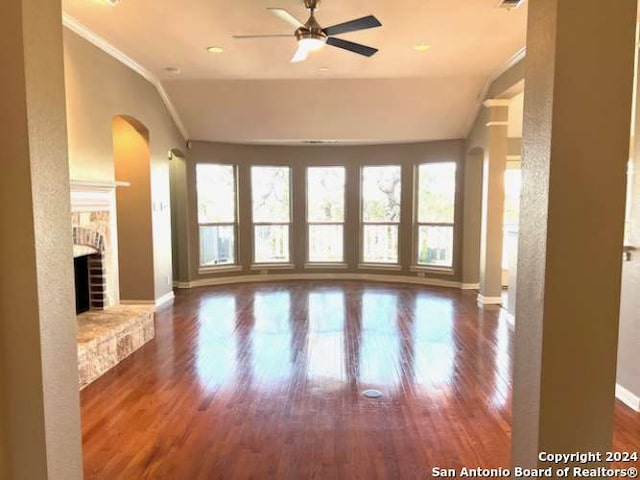 interior space featuring dark hardwood / wood-style floors, ceiling fan, crown molding, and vaulted ceiling