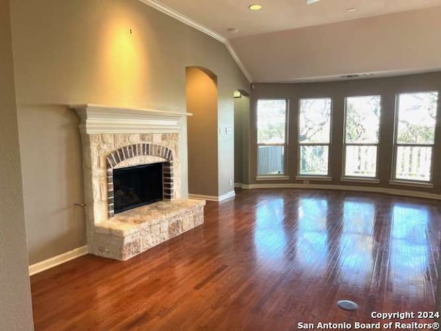 unfurnished living room with ornamental molding, vaulted ceiling, and hardwood / wood-style flooring