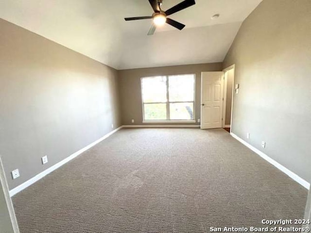 unfurnished room featuring carpet, ceiling fan, and vaulted ceiling