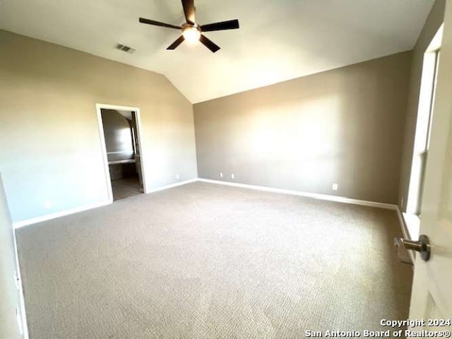 unfurnished bedroom with carpet, ensuite bath, ceiling fan, and lofted ceiling