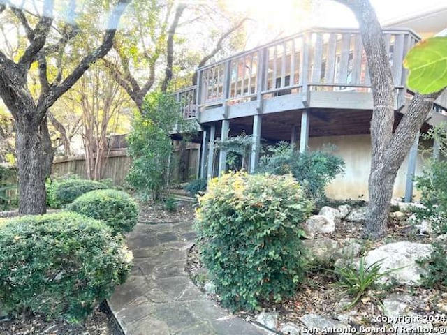 rear view of property featuring a wooden deck