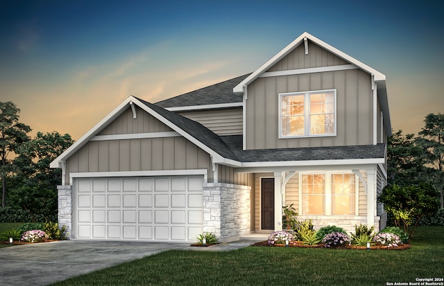 view of front of property with a garage and a yard