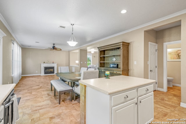 kitchen featuring white cabinets, pendant lighting, and ornamental molding