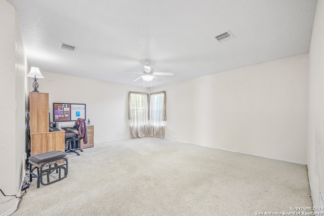 interior space featuring a textured ceiling and ceiling fan