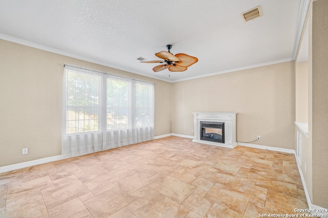 unfurnished living room featuring ceiling fan, a textured ceiling, and ornamental molding