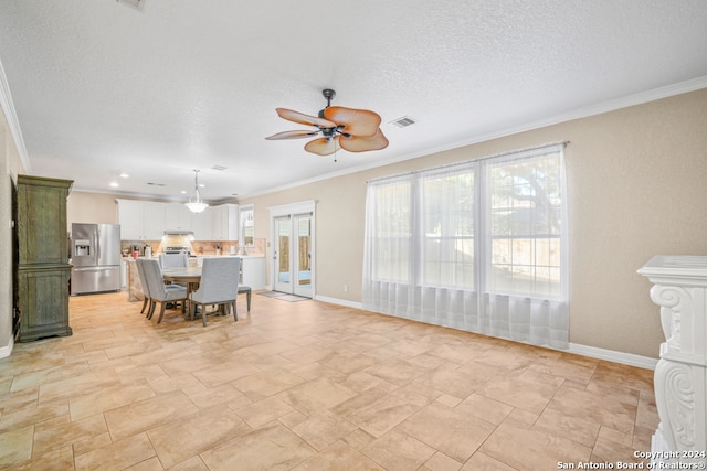 dining room featuring ceiling fan, ornamental molding, a textured ceiling, and french doors