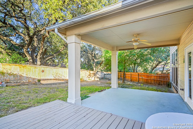 wooden deck featuring ceiling fan and a patio