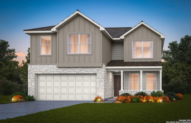 view of front of home with a yard and a garage