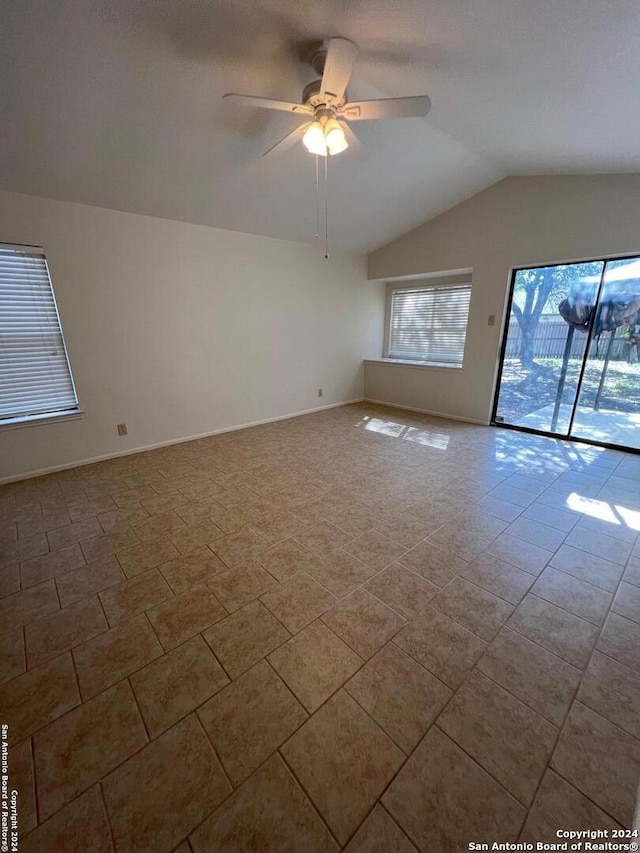 spare room featuring ceiling fan and vaulted ceiling