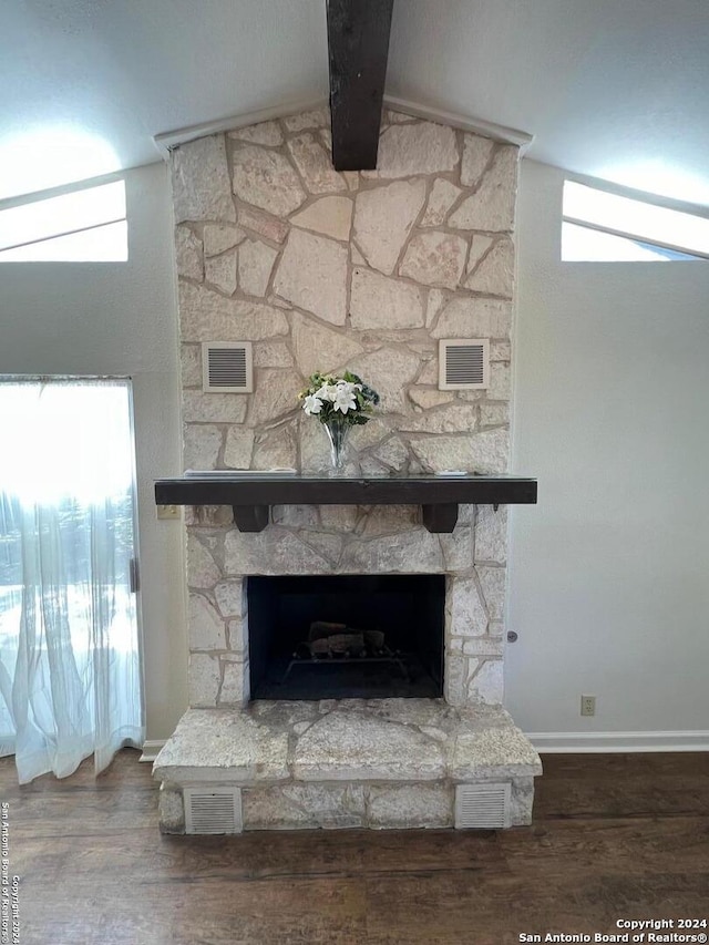 details with beamed ceiling, wood-type flooring, and a fireplace