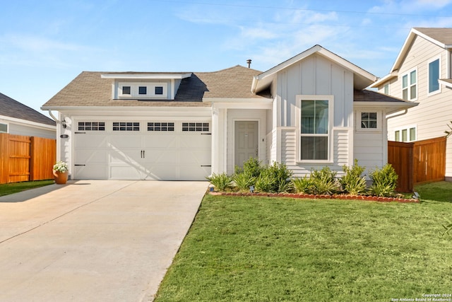 view of front of property featuring a garage and a front yard