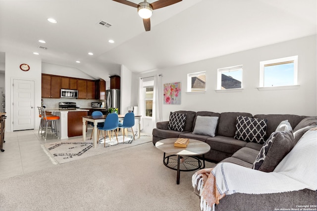 living room featuring ceiling fan, light tile patterned flooring, and lofted ceiling