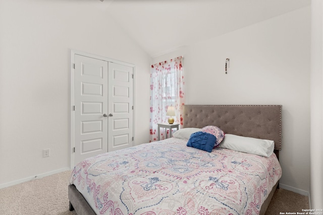 bedroom with lofted ceiling, carpet floors, and a closet