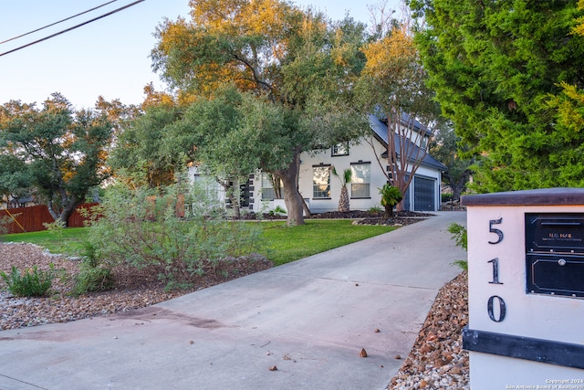 view of front of house with a front yard and a garage