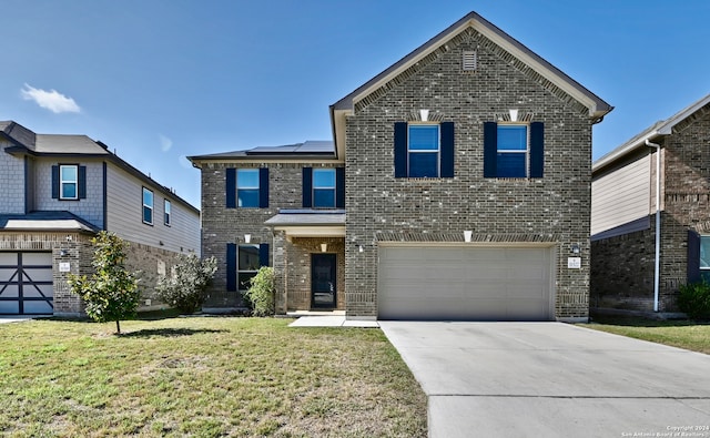 view of front of property featuring solar panels, a garage, and a front lawn