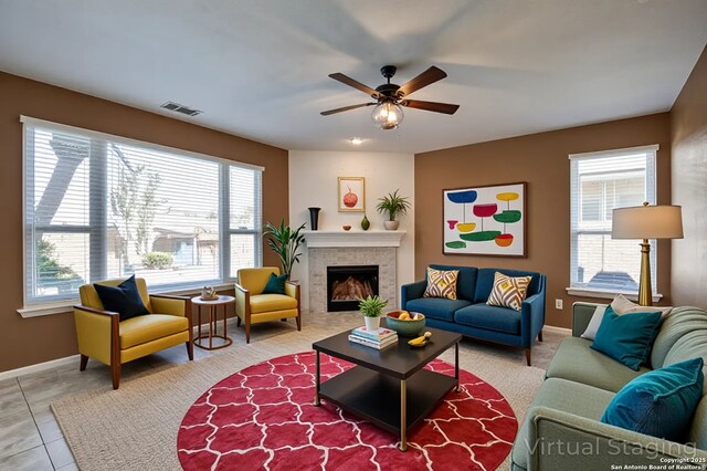 268 Fawn Rdg, Cibolo, TX 78108 - tiled living room with baseboards, ceiling fan, and a fireplace