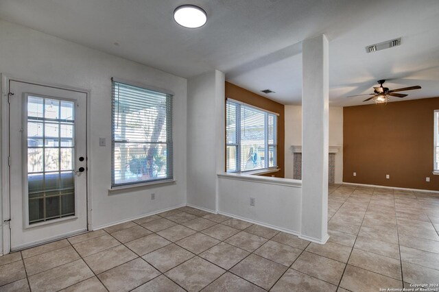268 Fawn Rdg, Cibolo, TX 78108 - unfurnished room with light tile patterned flooring, plenty of natural light, a ceiling fan, and baseboards