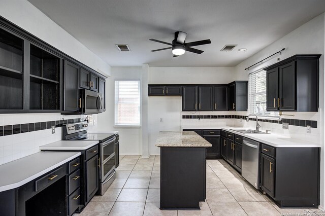 268 Fawn Rdg, Cibolo, TX 78108 - kitchen with appliances with stainless steel finishes, a sink, a center island, ceiling fan, and decorative backsplash