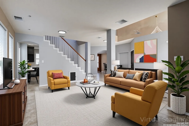 268 Fawn Rdg, Cibolo, TX 78108 - living area with arched walkways, stairway, and light tile patterned flooring