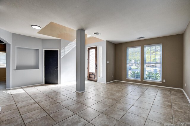 268 Fawn Rdg, Cibolo, TX 78108 - empty room featuring tile patterned flooring, baseboards, and arched walkways