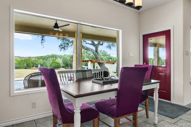 tiled dining area featuring ceiling fan and a healthy amount of sunlight