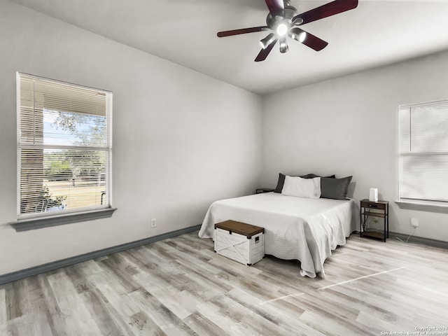 bedroom with ceiling fan and light hardwood / wood-style flooring