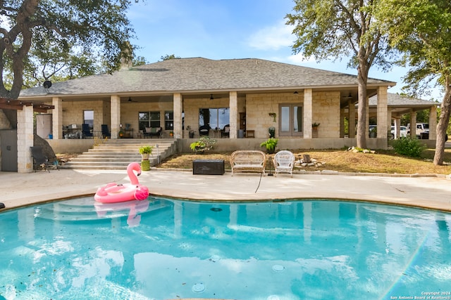 view of pool with a patio and ceiling fan