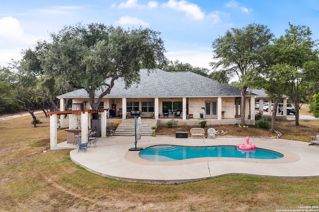 view of pool featuring a lawn and a patio area