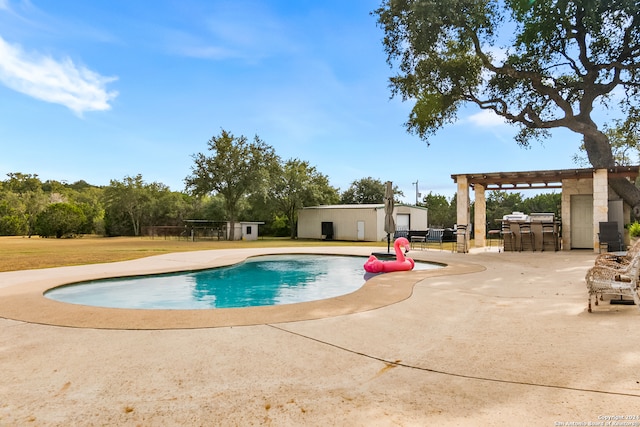 view of pool with a pergola, an outdoor bar, and a patio area