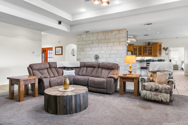 carpeted living room featuring ceiling fan