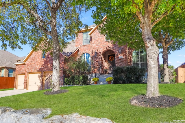 view of front of property featuring a front yard and a garage