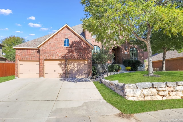 view of front of property with a garage and a front lawn