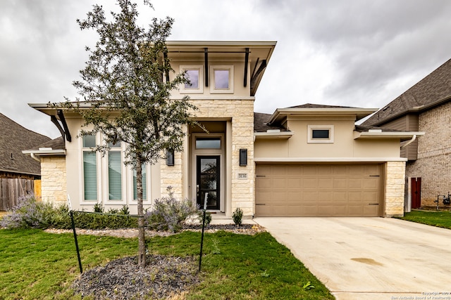 view of front facade featuring a garage and a front lawn