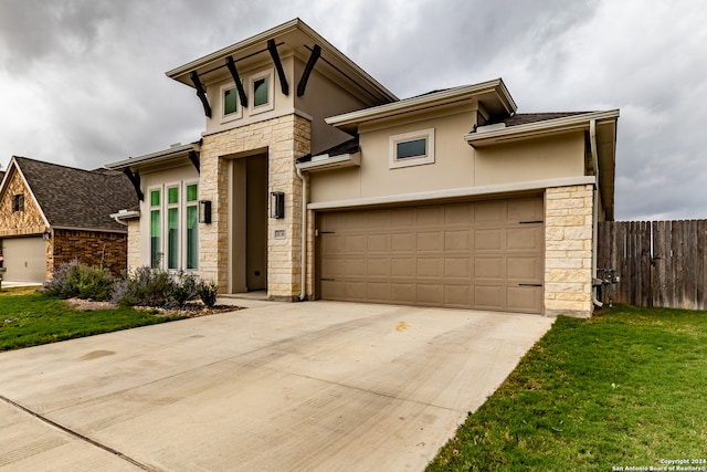 view of front of house featuring a front yard and a garage