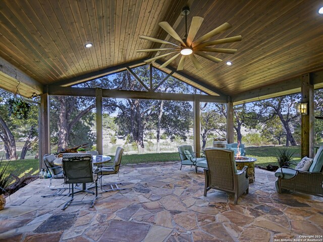 sunroom / solarium featuring ceiling fan, lofted ceiling, and wooden ceiling