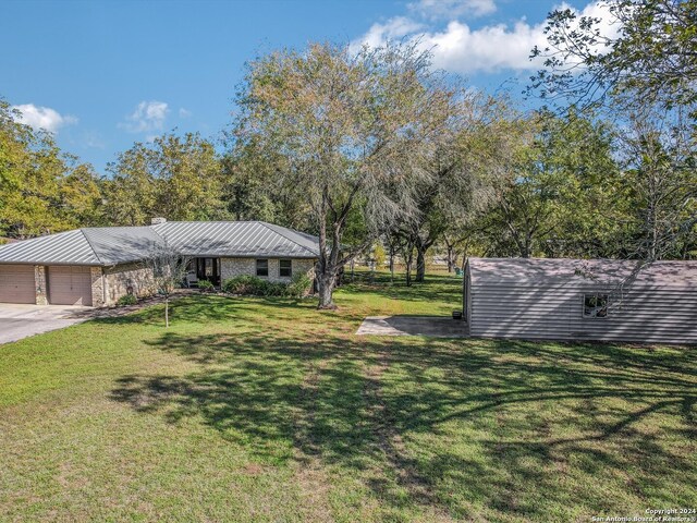 view of front of house featuring a garage and a front lawn