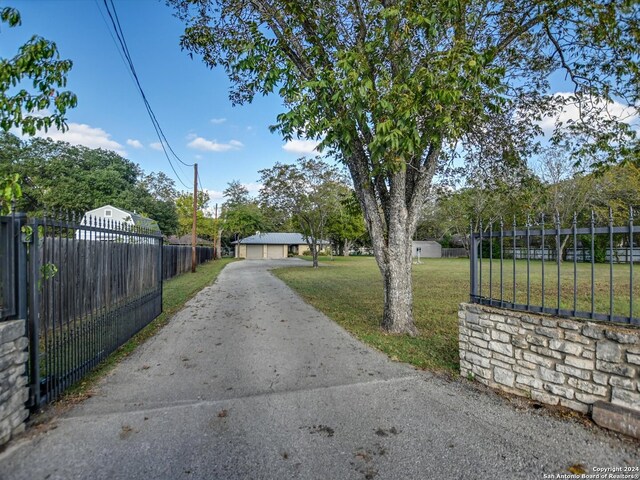 view of gate featuring a lawn