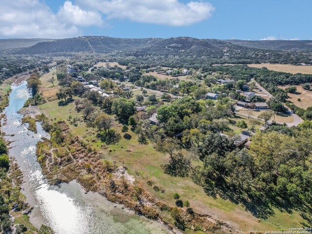 birds eye view of property with a water and mountain view