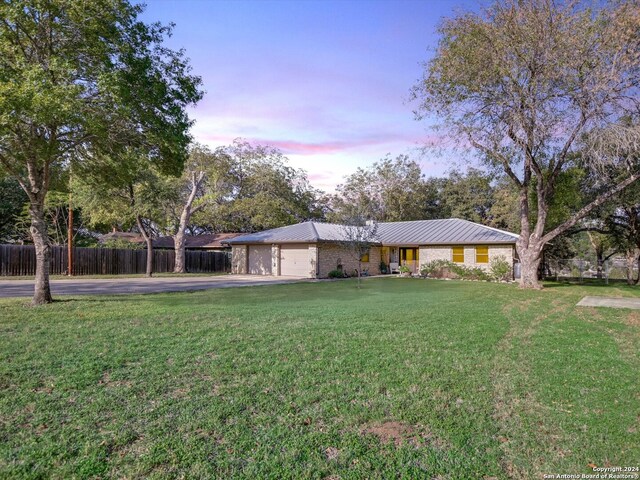 view of front facade with a garage and a yard